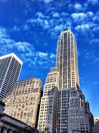 Low angle view of modern building against cloudy sky