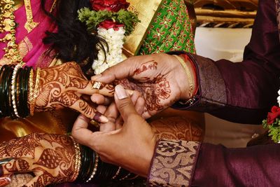 Midsection of woman with hand holding hands