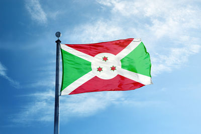 Low angle view of flag against blue sky