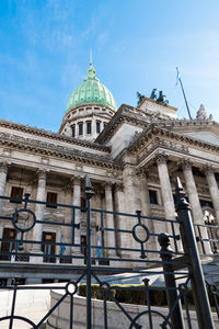 Low angle view of historical building against cloudy sky