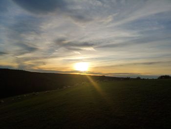 Scenic view of sunset over land