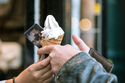 Close-up of hands holding ice cream