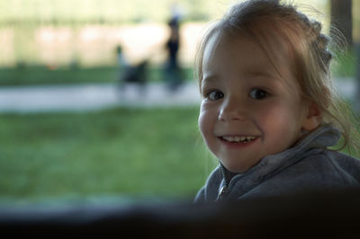 Portrait of cute girl smiling outdoors