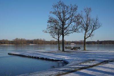 Scenic view of frozen lake against sky during winter