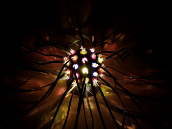 Close-up of illuminated street lights at night