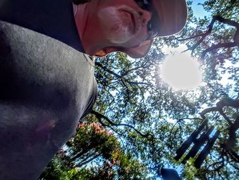 Low angle portrait of young man against sky