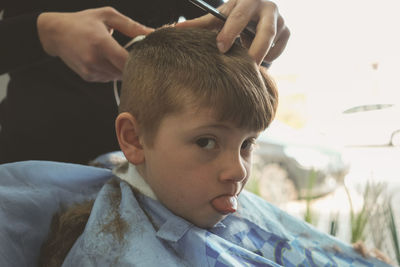 Close-up of boy with hand