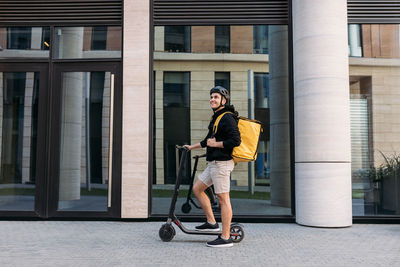 Full length of man riding skateboard