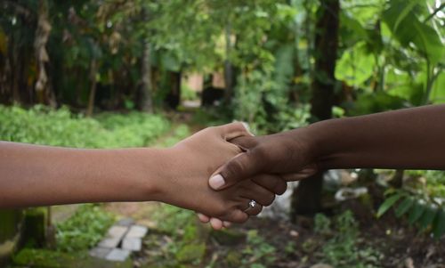 Handshake, between a white and a black young man, black lives matter. selective focus.