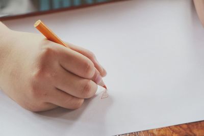 Close-up of hand holding paper