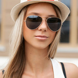 Close-up portrait of young woman wearing sunglasses