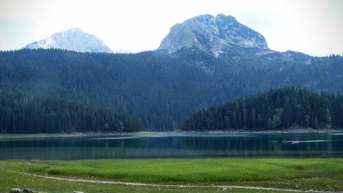 Scenic view of lake and mountains against sky