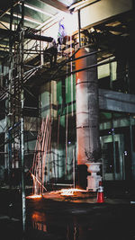 Low angle view of illuminated construction site at night