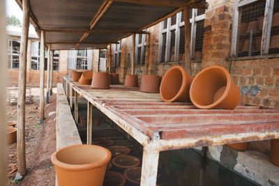 Close-up of clay pots on shelf at warehouse