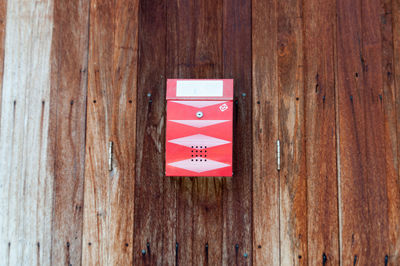 Red mailbox on wooden door
