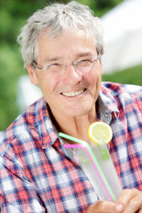 Close-up of smiling man holding cocktail glass