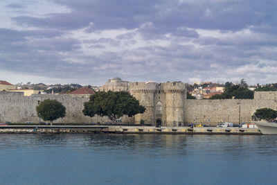 Harbour area and city gate in the old town of rhodes, greece, in early morning light