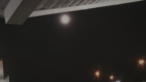 Low angle view of illuminated lights at night