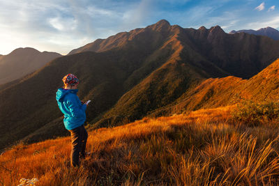 Man standing on mountain against sky