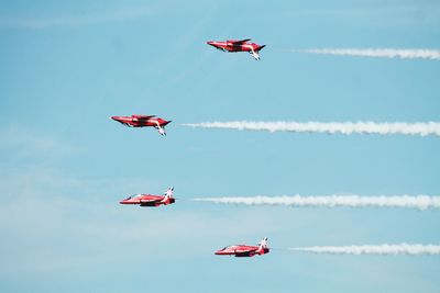 Low angle view of airshow against sky