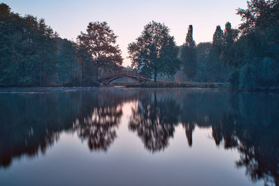 Reflection of trees in lake against sky