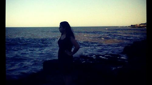 Scenic view of calm beach at sunset