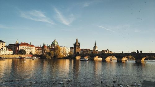 Charles bridge over river with buildings in background