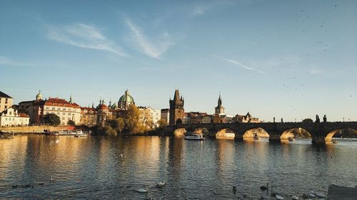 Bridge over river with buildings in background