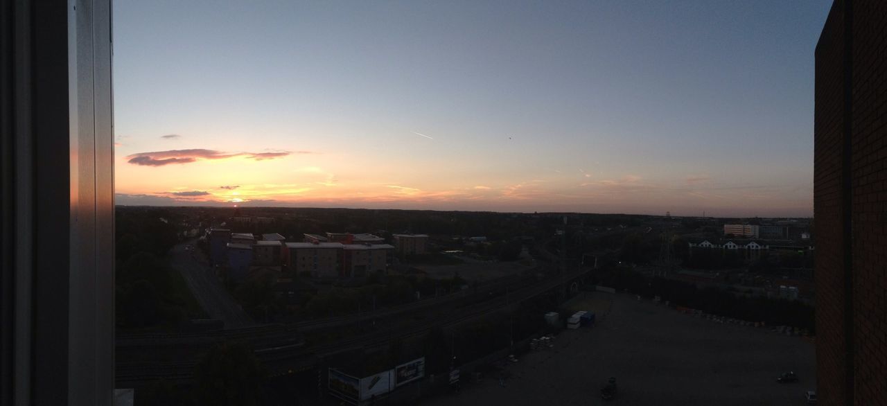 sunset, architecture, built structure, building exterior, sky, cityscape, city, high angle view, orange color, residential structure, indoors, water, residential district, window, residential building, silhouette, dusk, nature, house, no people