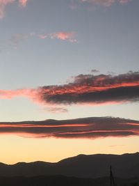 Scenic view of silhouette mountains against sky at sunset