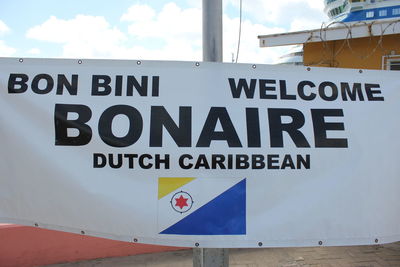 Information sign against sky