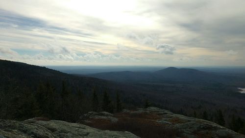 Scenic view of mountains against cloudy sky