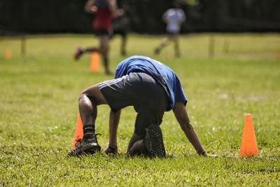 Rear view of man playing on field