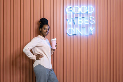 Woman standing by coffee cup