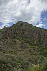 Low angle view of rocky mountain against sky