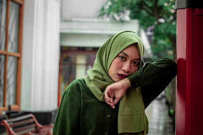 Portrait of young woman wearing hijab in city