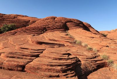 Low angle landscape of rounded red rock formations in snow canyon state park in utah