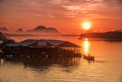 Scenic view of sea against orange sky