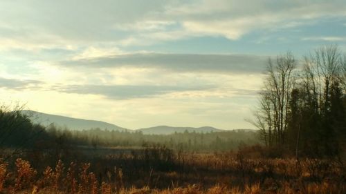 Scenic view of mountains against cloudy sky