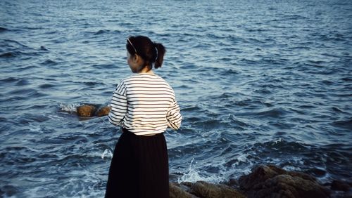 Rear view of woman looking at sea