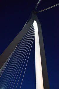 Low angle view of suspension bridge against clear blue sky