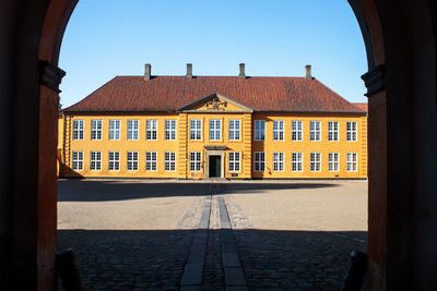 Yellow building against sky in roskilde