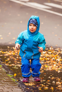 Portrait of boy standing in snow