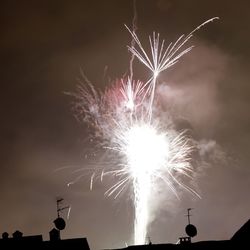 Low angle view of firework display at night