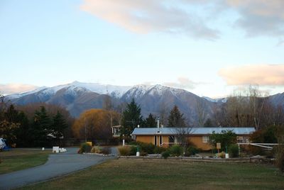 Built structure by trees against sky