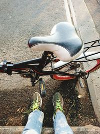 Low section of person riding bicycle on street