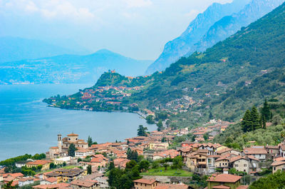 High angle view of townscape by mountain against sky