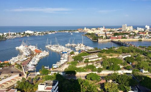 High angle view of buildings by sea against sky