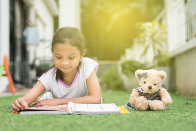 Close-up of boy with dog on book