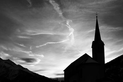 Low angle view of church against cloudy sky